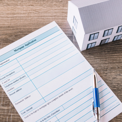 ADU mortgage and permit paperwork with model house – Best ADU LA